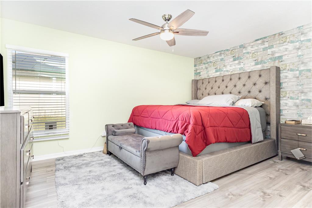 1760 Canaan Loop Dundee, FL 33838 - Photo 13 of 25 a bedroom with a bed and a couch
