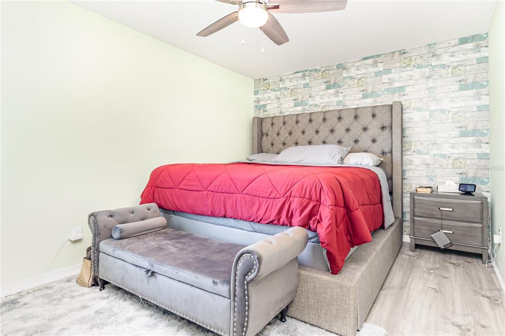 1760 Canaan Loop Dundee, FL 33838 - Photo 14 of 25 a bedroom with a bed and a ceiling fan