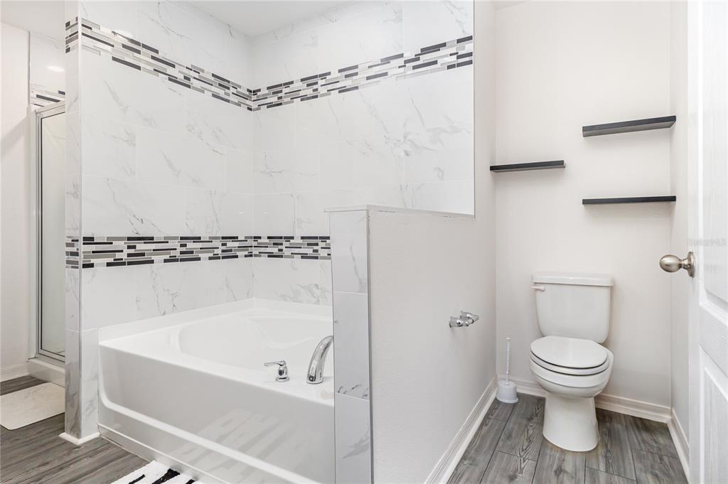 1760 Canaan Loop Dundee, FL 33838 - Photo 18 of 25 a bathroom with a toilet and a shower