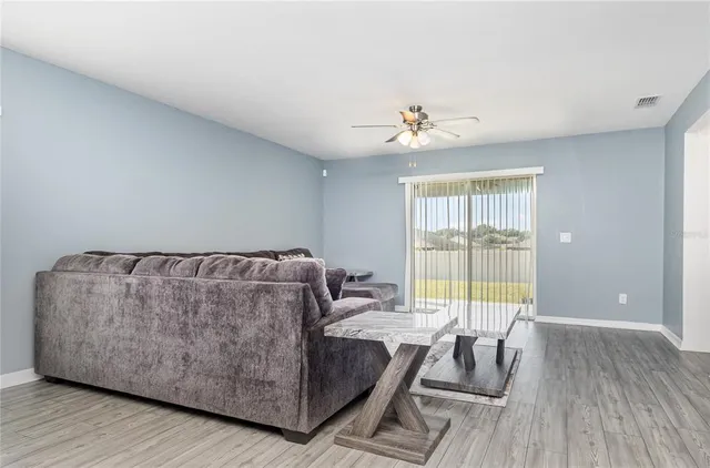 a living room with furniture and a large window