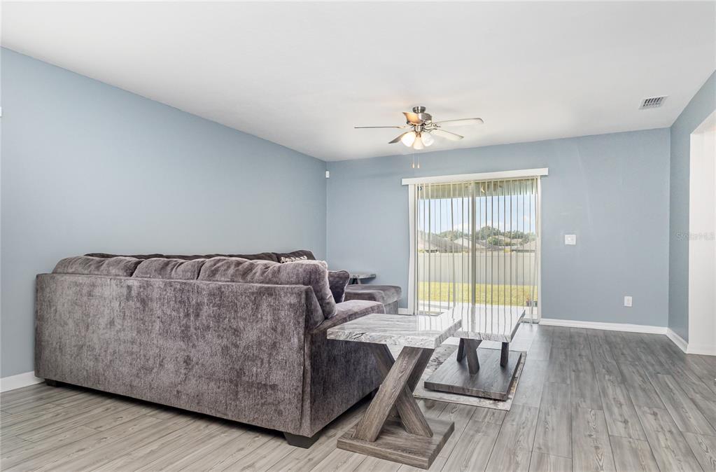 1760 Canaan Loop Dundee, FL 33838 - Photo 2 of 25 a living room with furniture and a large window