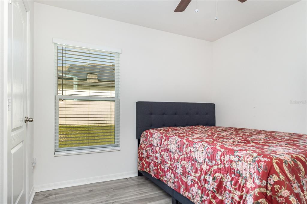 1760 Canaan Loop Dundee, FL 33838 - Photo 21 of 25 a bedroom with a large bed and a window
