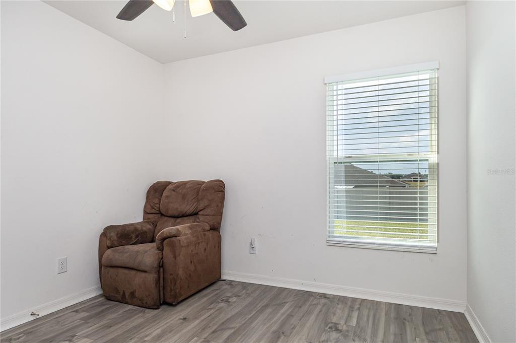 1760 Canaan Loop Dundee, FL 33838 - Photo 23 of 25 a living room with furniture and a window