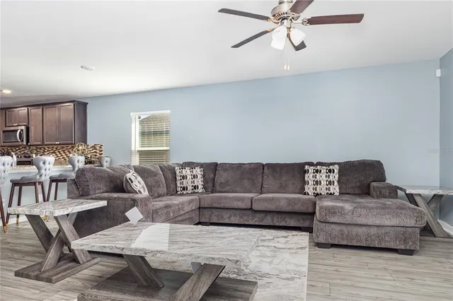 a living room with furniture and a wooden floor