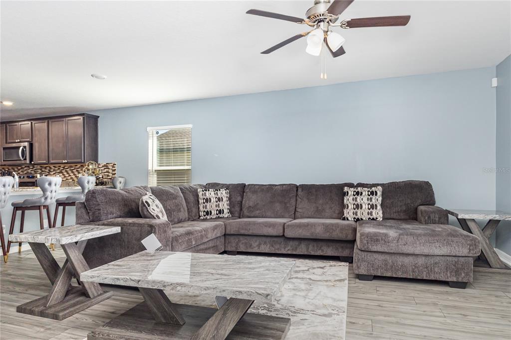 1760 Canaan Loop Dundee, FL 33838 - Photo 3 of 25 a living room with furniture and a wooden floor