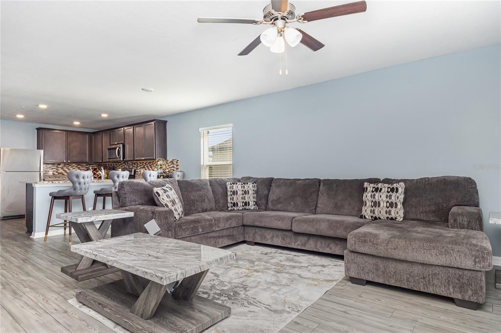 1760 Canaan Loop Dundee, FL 33838 - Photo 4 of 25 a living room with furniture and a view of kitchen