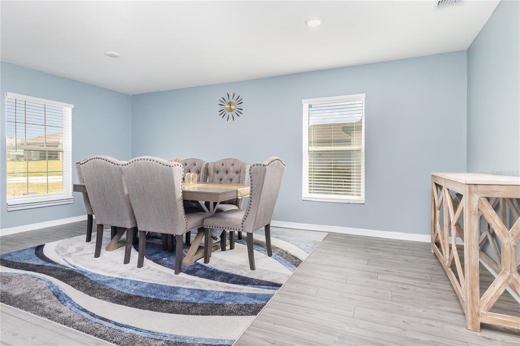1760 Canaan Loop Dundee, FL 33838 - Photo 5 of 25 a view of a dining room with furniture window and wooden floor