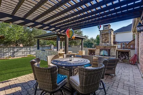 a patio with a table and chairs