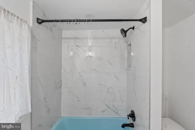 a bathroom with a shower and a shower