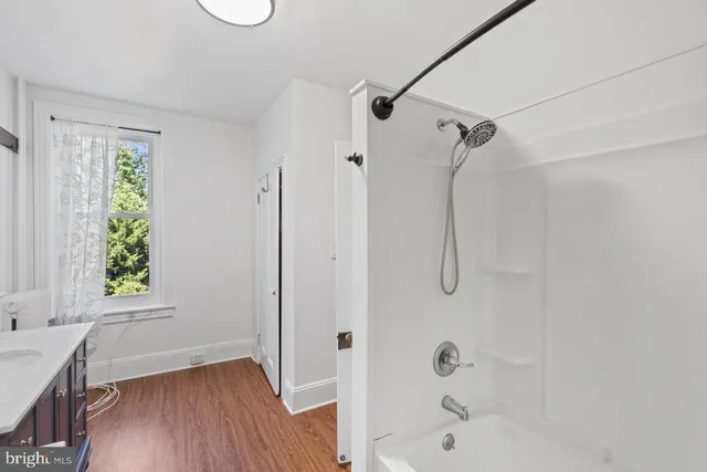 a bathroom with a bathtub and a window