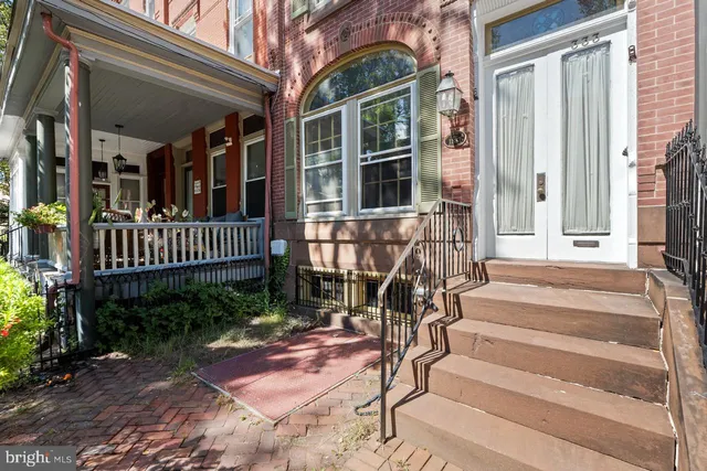 a view of staircase with railing and a rug
