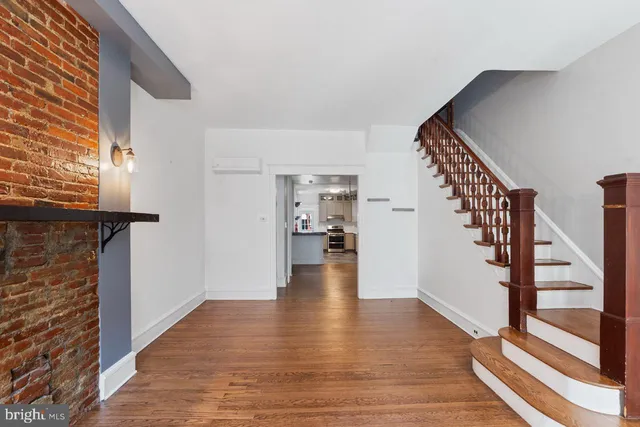 a view of an entryway with wooden floor and staircase