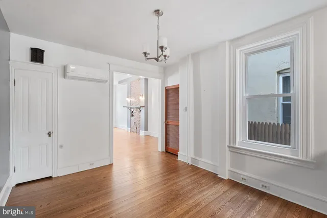 a view of a room with wooden floor closet and windows
