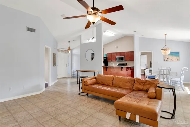 a living room with furniture and a ceiling fan
