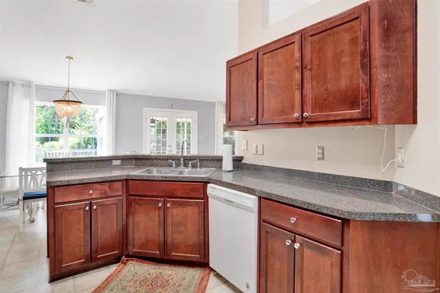 a kitchen with stainless steel appliances granite countertop wooden cabinets a sink and a stove