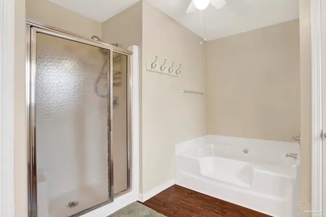 a bathroom with a shower and a bath tub