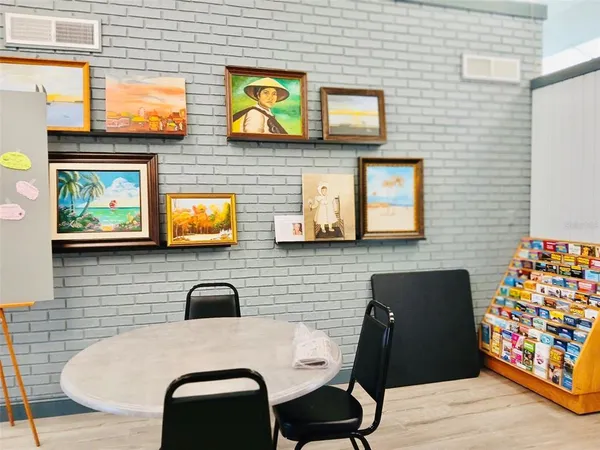 a view of a workspace with furniture and a bookshelf