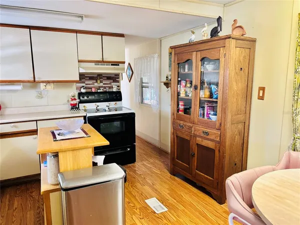 a kitchen with stainless steel appliances a stove sink and cabinets