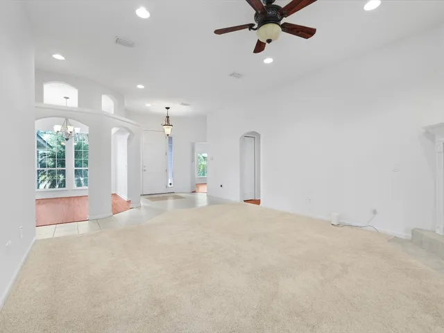 a view of a room with wooden floor chandelier and entryway
