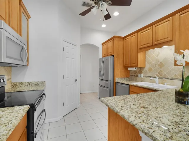 a kitchen with cabinets a sink and appliances