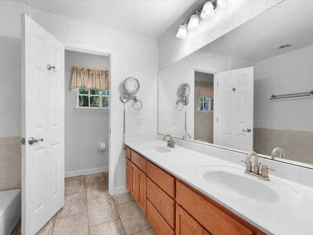 a bedroom with bed and wall painting