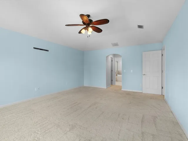 a view of a livingroom with a ceiling fan and wooden floor