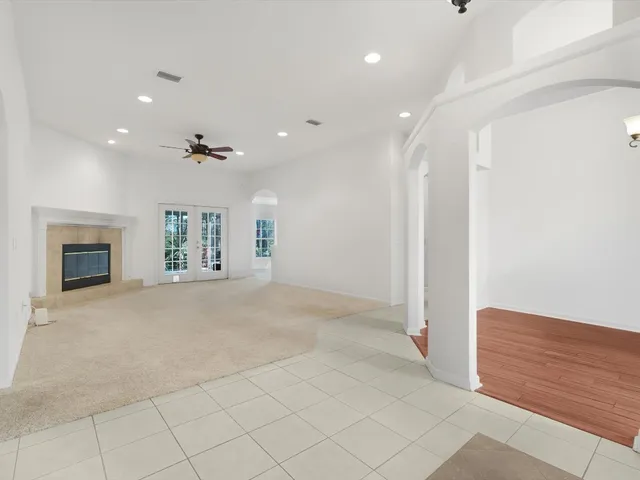 an empty room with fireplace and fan