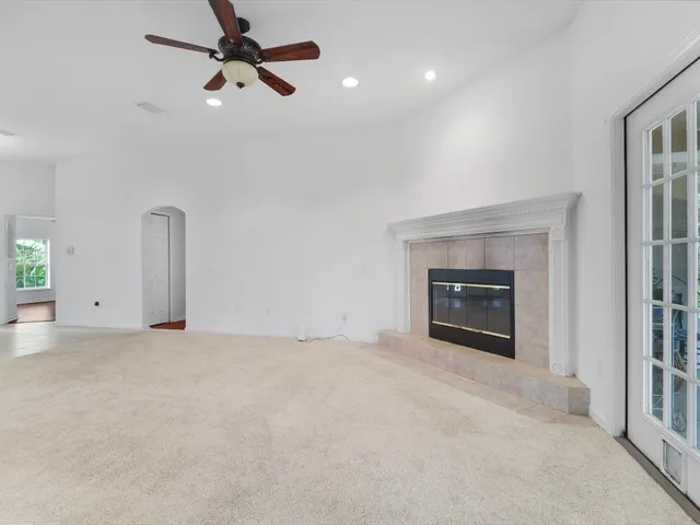 an empty room with fan and windows