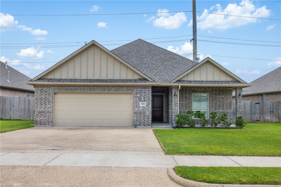 3088 Peterson Circle Bryan, TX 77802 - Photo 1 of 29 Single story home with board and batten siding, a shingled roof, brick siding, concrete driveway, and a garage