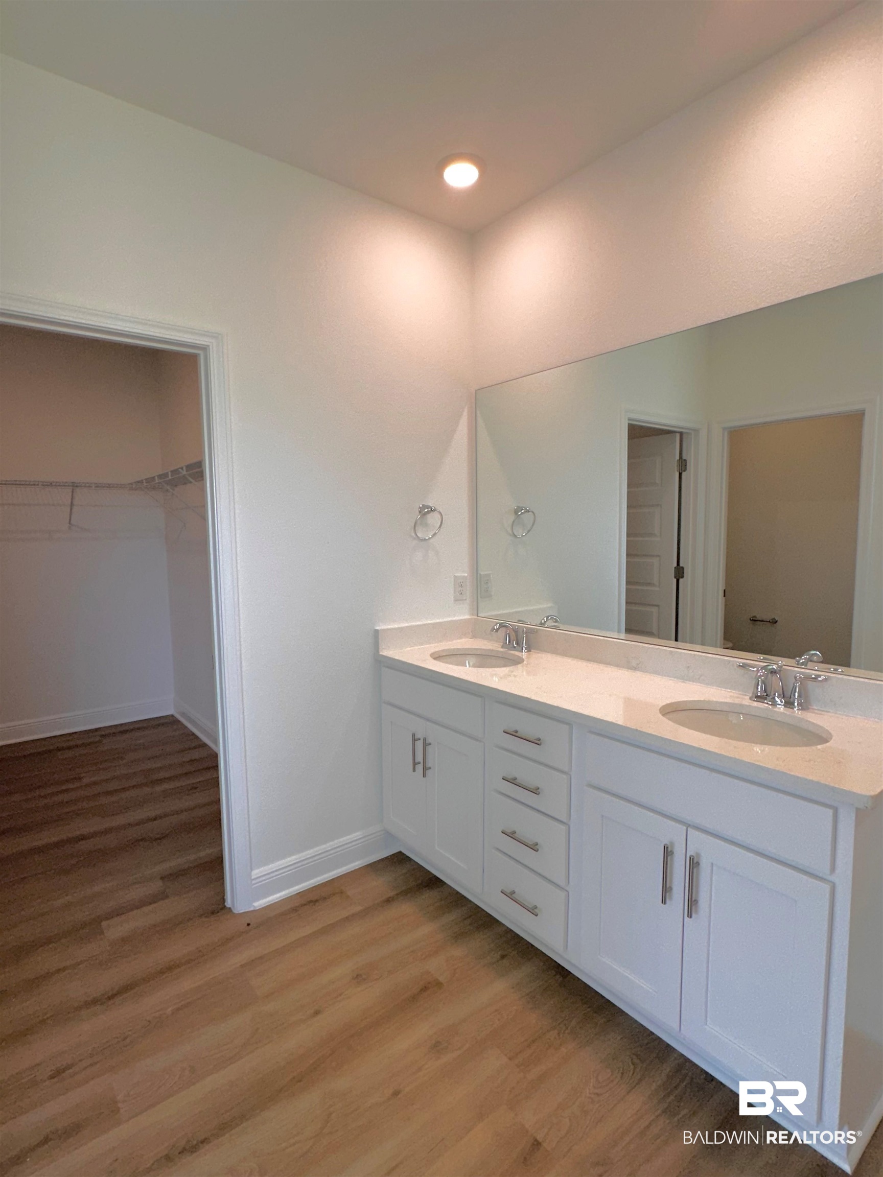 12946 Grand Rpds Road Fairhope, AL 36532 - Photo 12 of 19 Bathroom featuring double vanity and hardwood / wood-style flooring