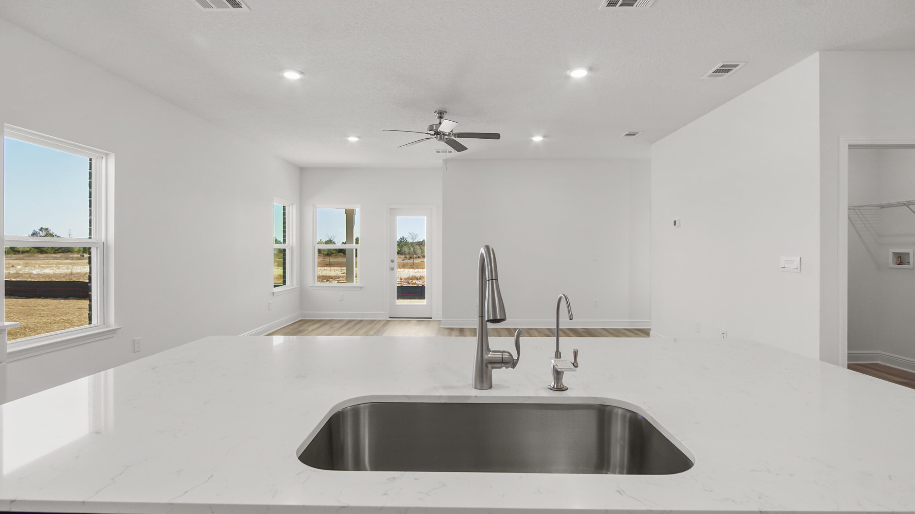 76 Grass Owl Loop Freeport, FL 32439 - Photo 16 of 39 a kitchen with a sink and a refrigerator