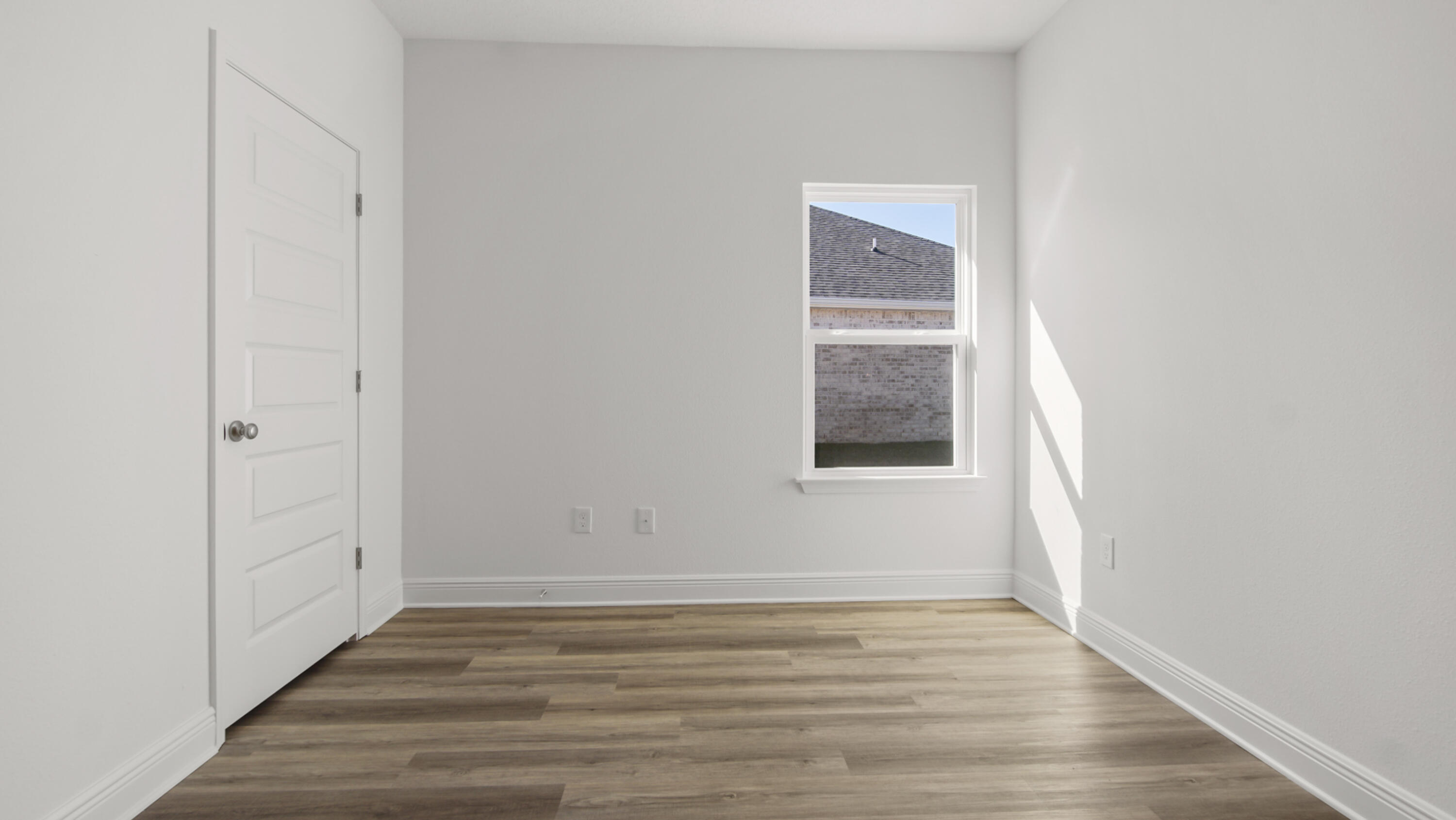 76 Grass Owl Loop Freeport, FL 32439 - Photo 20 of 39 a view of an empty room with wooden floor and a window