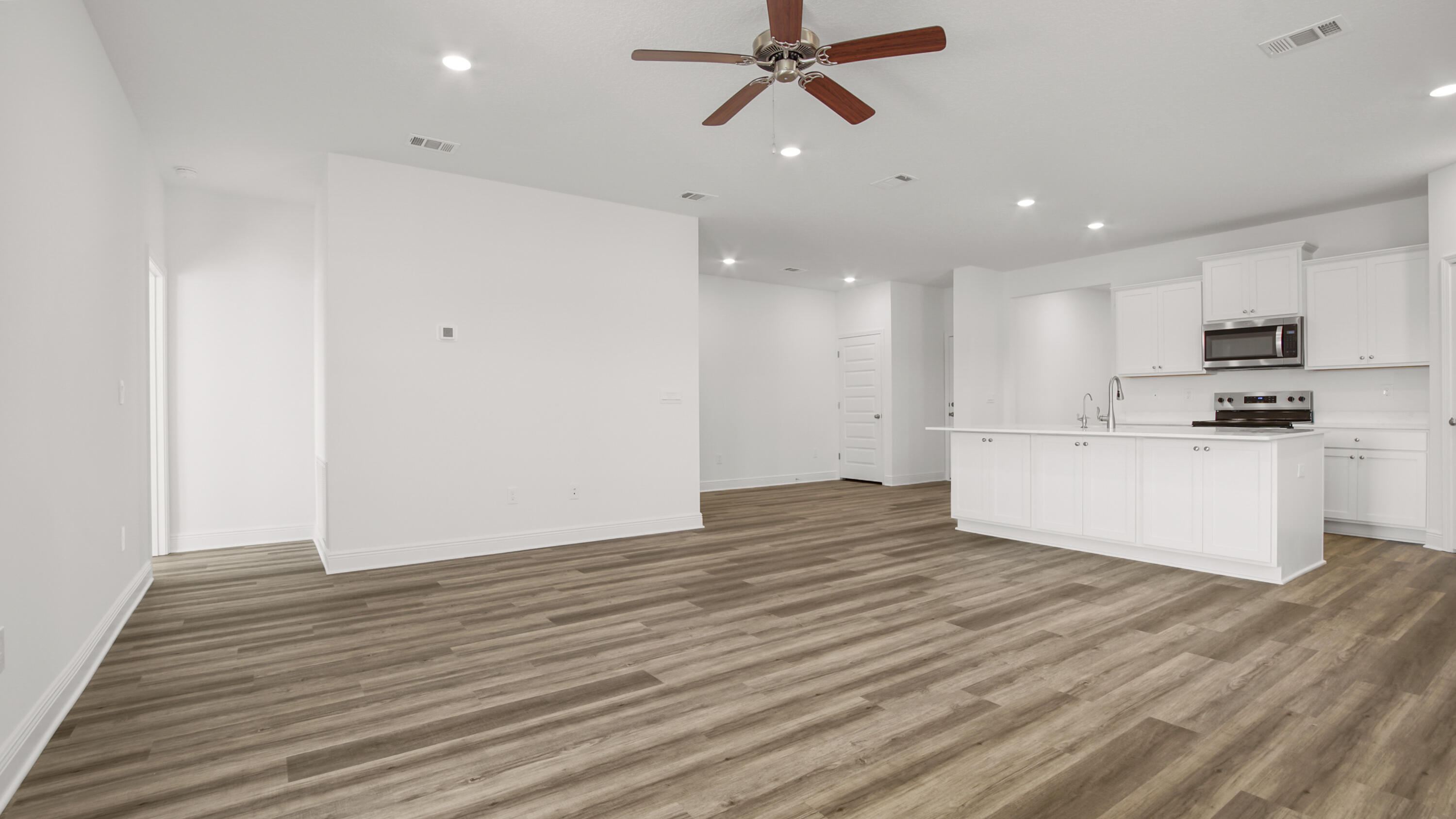 76 Grass Owl Loop Freeport, FL 32439 - Photo 33 of 39 a view of a kitchen with a sink and wooden floor