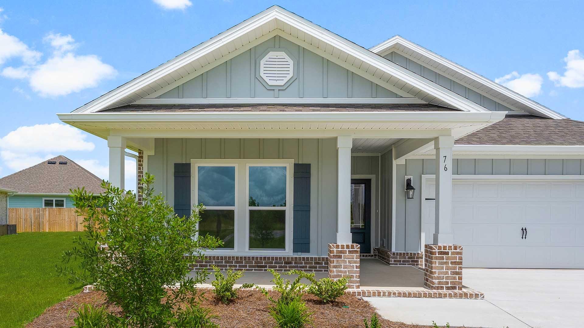 76 Grass Owl Loop Freeport, FL 32439 - Photo 35 of 39 a front view of a house with a yard