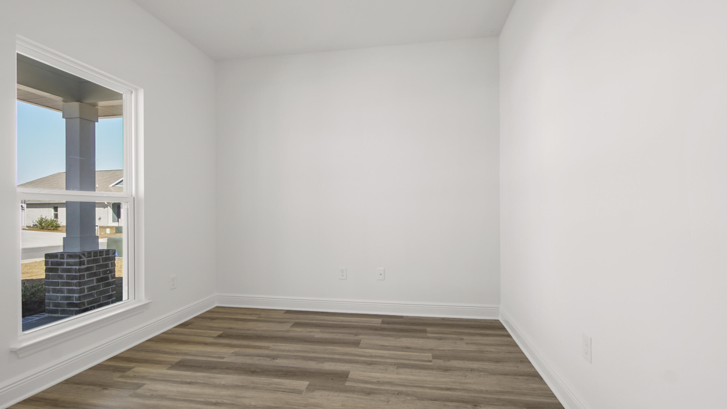 76 Grass Owl Loop Freeport, FL 32439 - Photo 5 of 39 a view of an empty room with wooden floor and a window