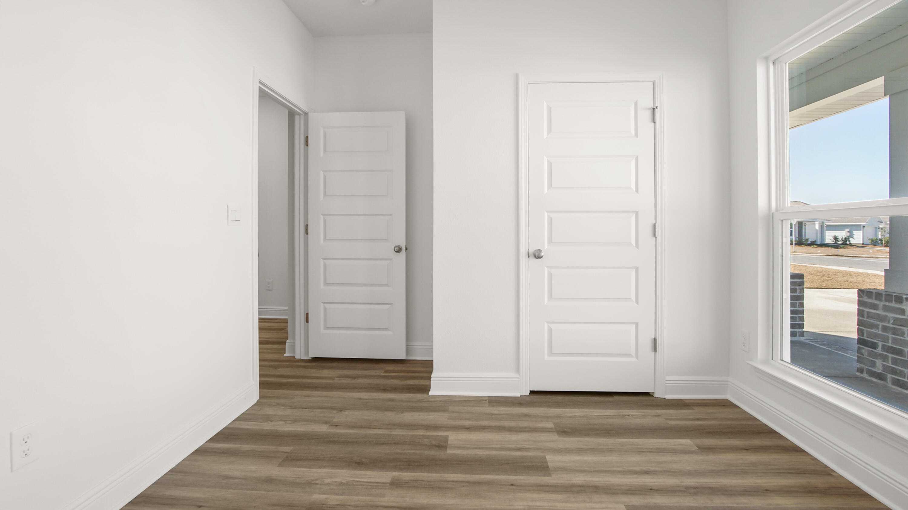 76 Grass Owl Loop Freeport, FL 32439 - Photo 6 of 39 a view of an empty room with wooden floor and a window