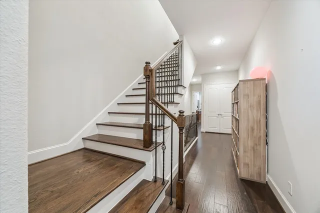 a view of entryway and hall with wooden floor