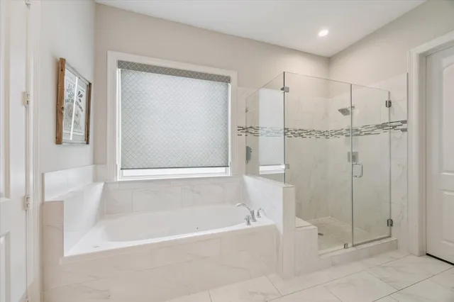 a bathroom with a bathtub and a shower