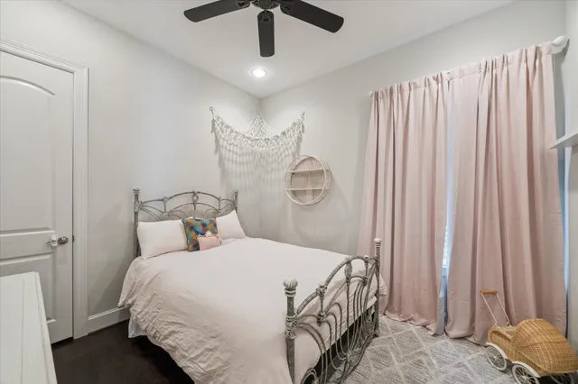 a bedroom with bed and a chandelier