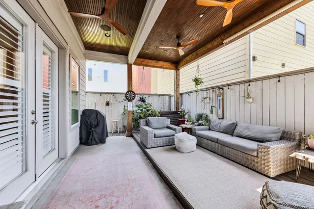 a living room with furniture fireplace and a large window