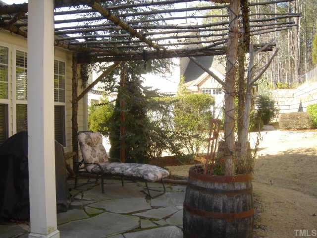 8508 Flying Buttress Drive Raleigh, NC 27613 - Photo 3 of 12 a view of a porch with chairs and a tree