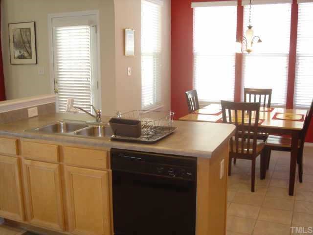 8508 Flying Buttress Drive Raleigh, NC 27613 - Photo 7 of 12 a kitchen with sink cabinets and dining table