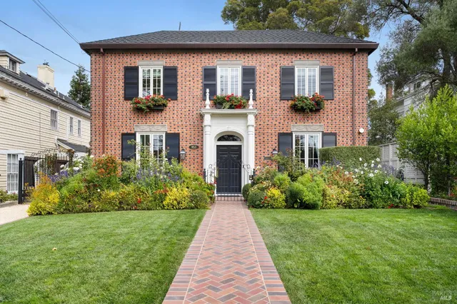 a front view of house with yard and green space