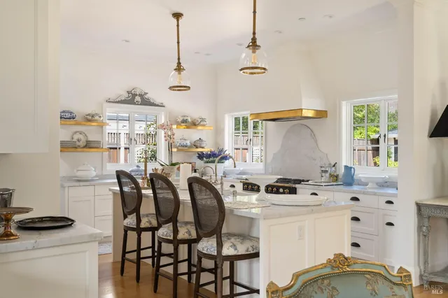 a kitchen with stainless steel appliances kitchen island granite countertop a sink and cabinets