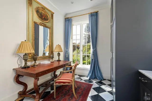 a view of a workspace with furniture and a window