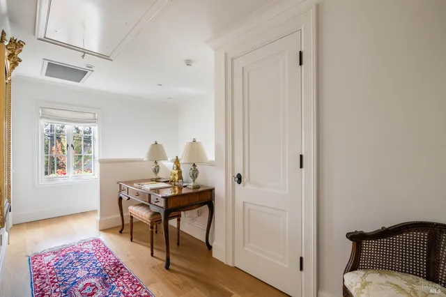 a view of a workspace with furniture and a window