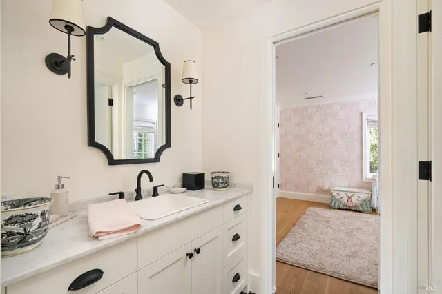 a bathroom with a granite countertop sink and a mirror