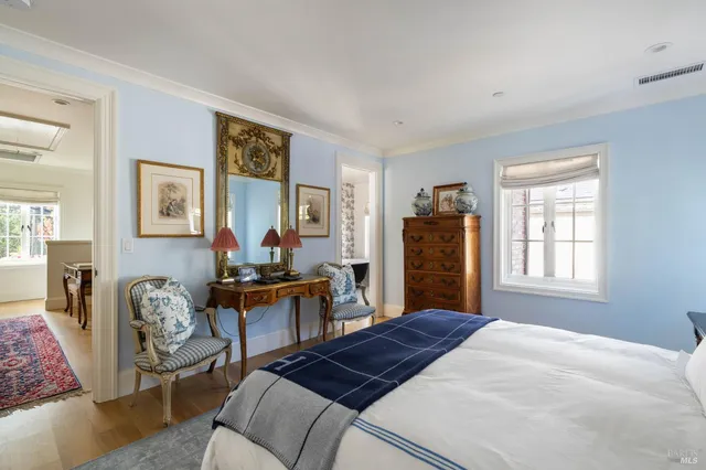 a bed room with a bed and a chair