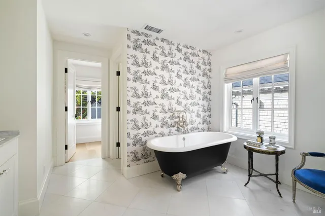 a spacious bathroom with a bathtub and a sink