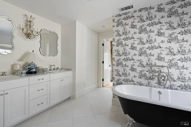 a bathroom with a bathtub sink and mirror